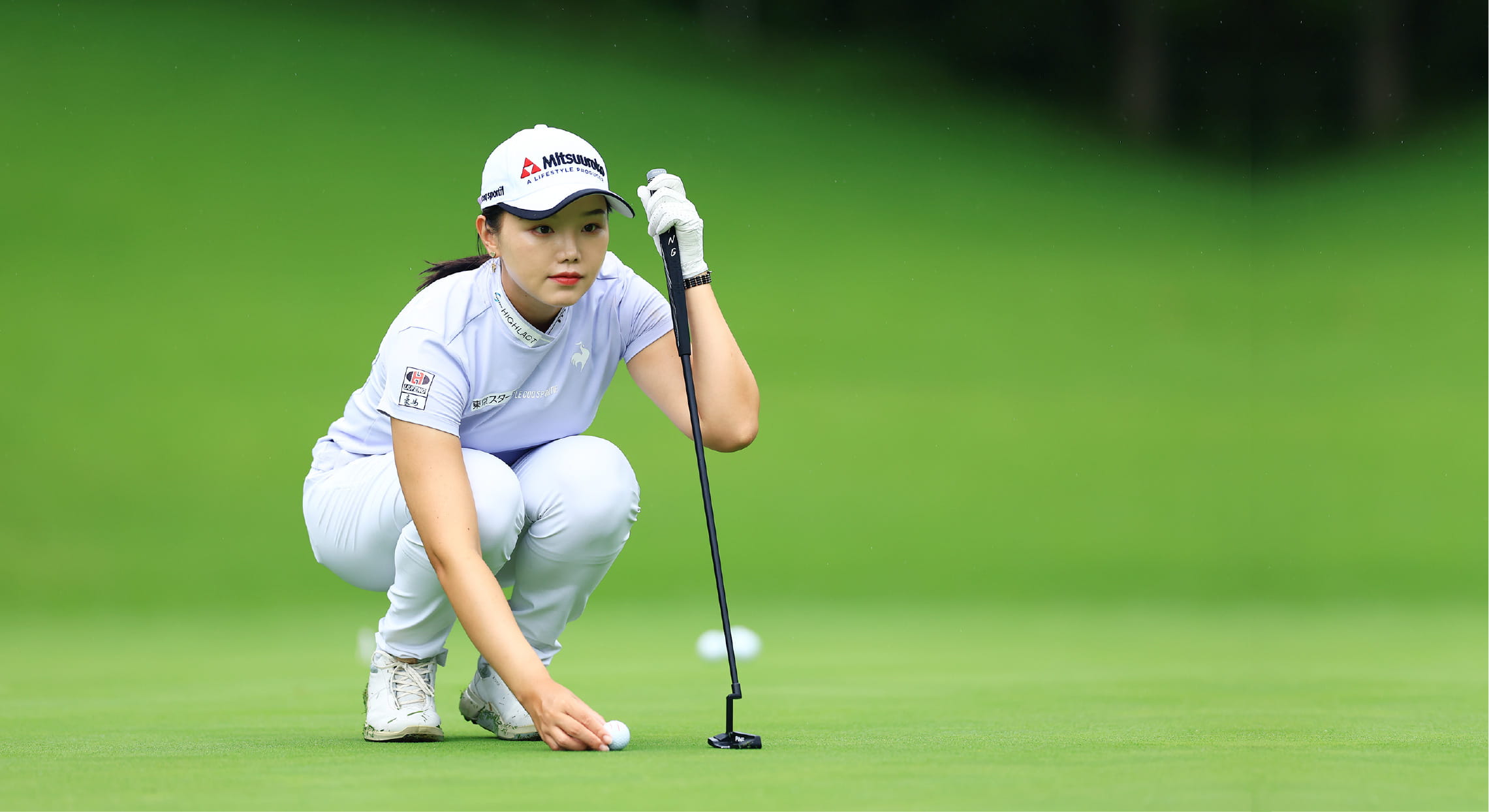 石昱婷选手正在放置高爾夫球，凝視著前方。